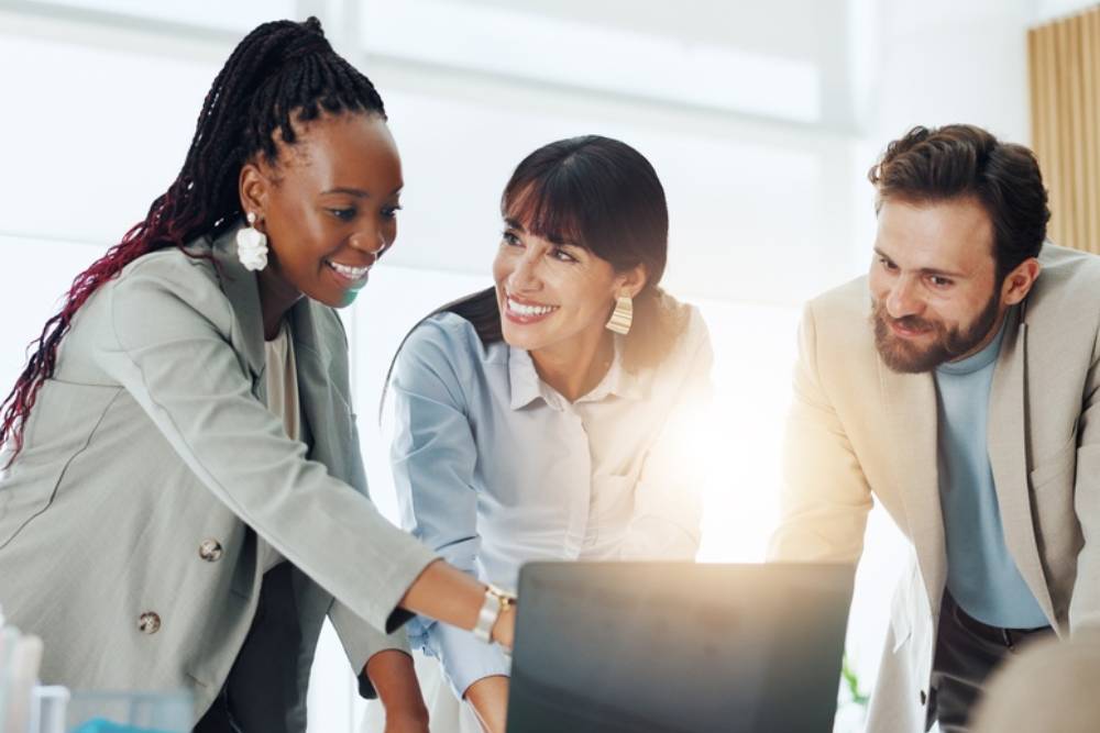 Happy, team and people with laptop, meeting and planning for investment proposal or risk assessment.